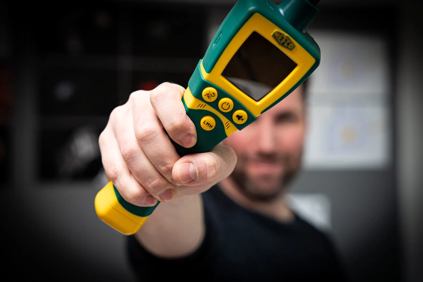 Pirmin Giger holding the REFCO Tritector leak detector up to the camera